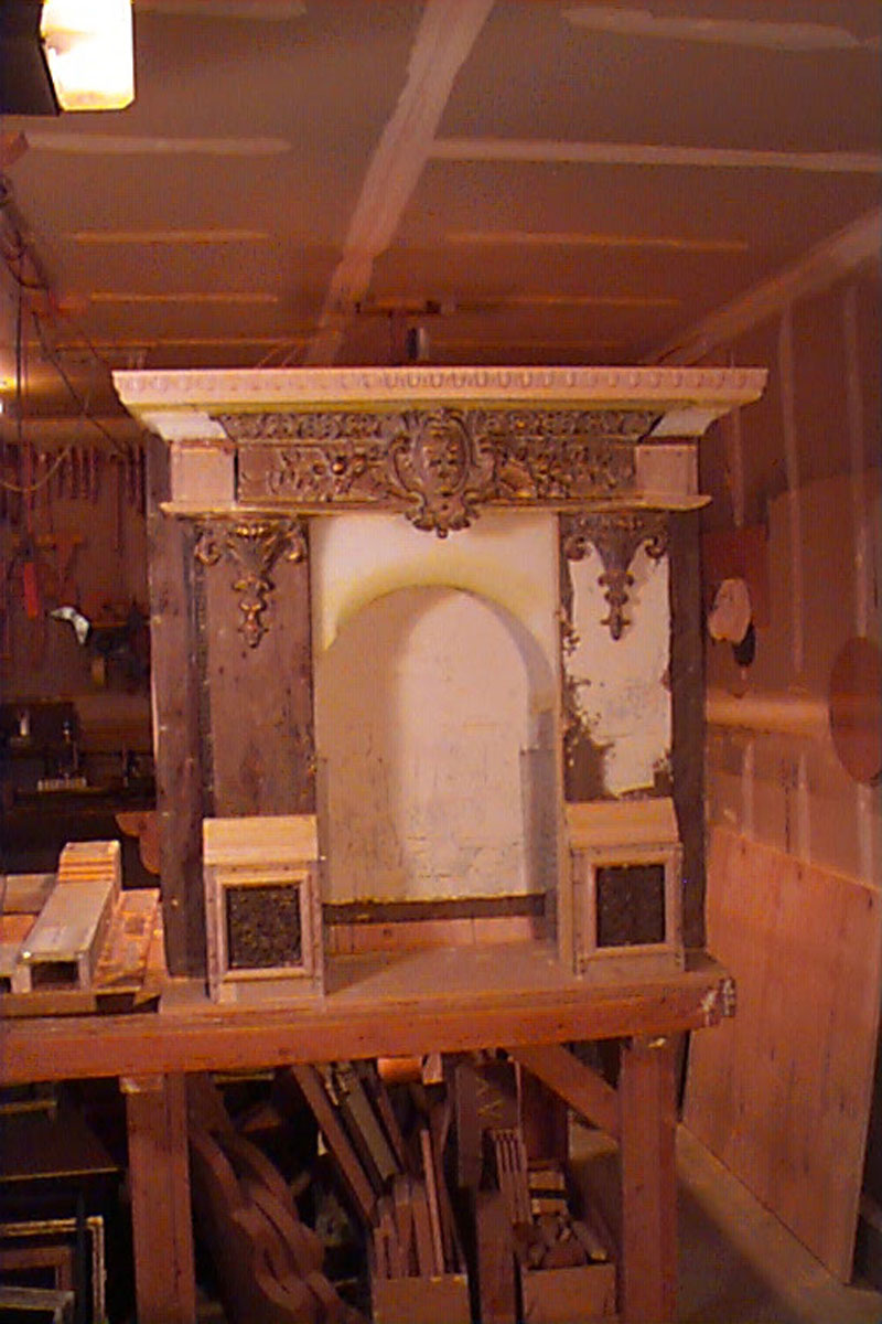 The faux fireplace takes shape on the workbench.