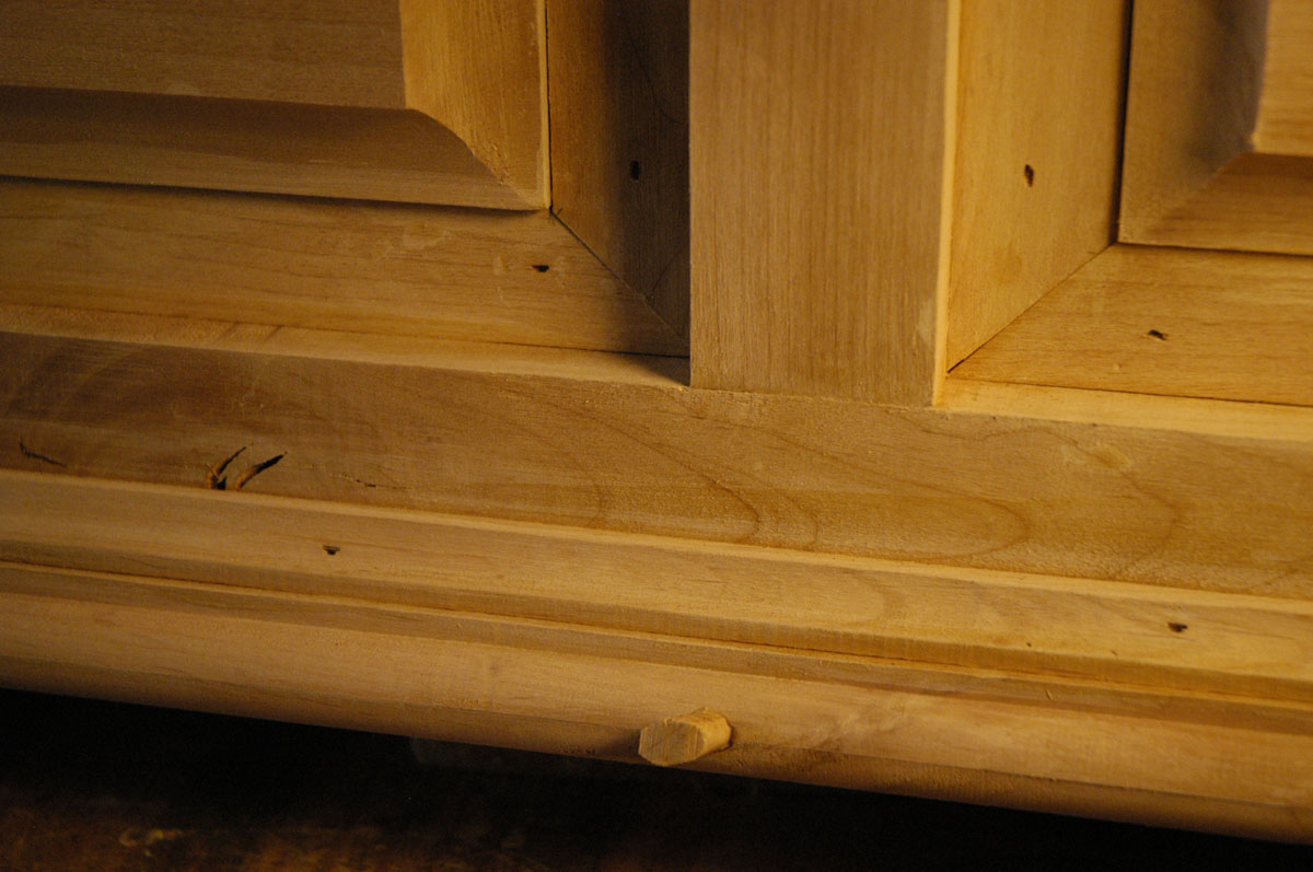 Exposed areas of plywood have been covered with thin strips of alder.  Holes in the alder ...