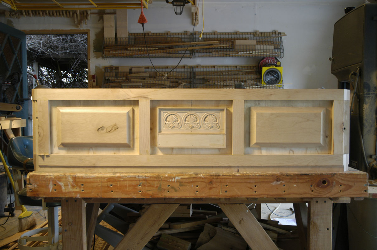 Raised-panel elements on the front of the chest.
