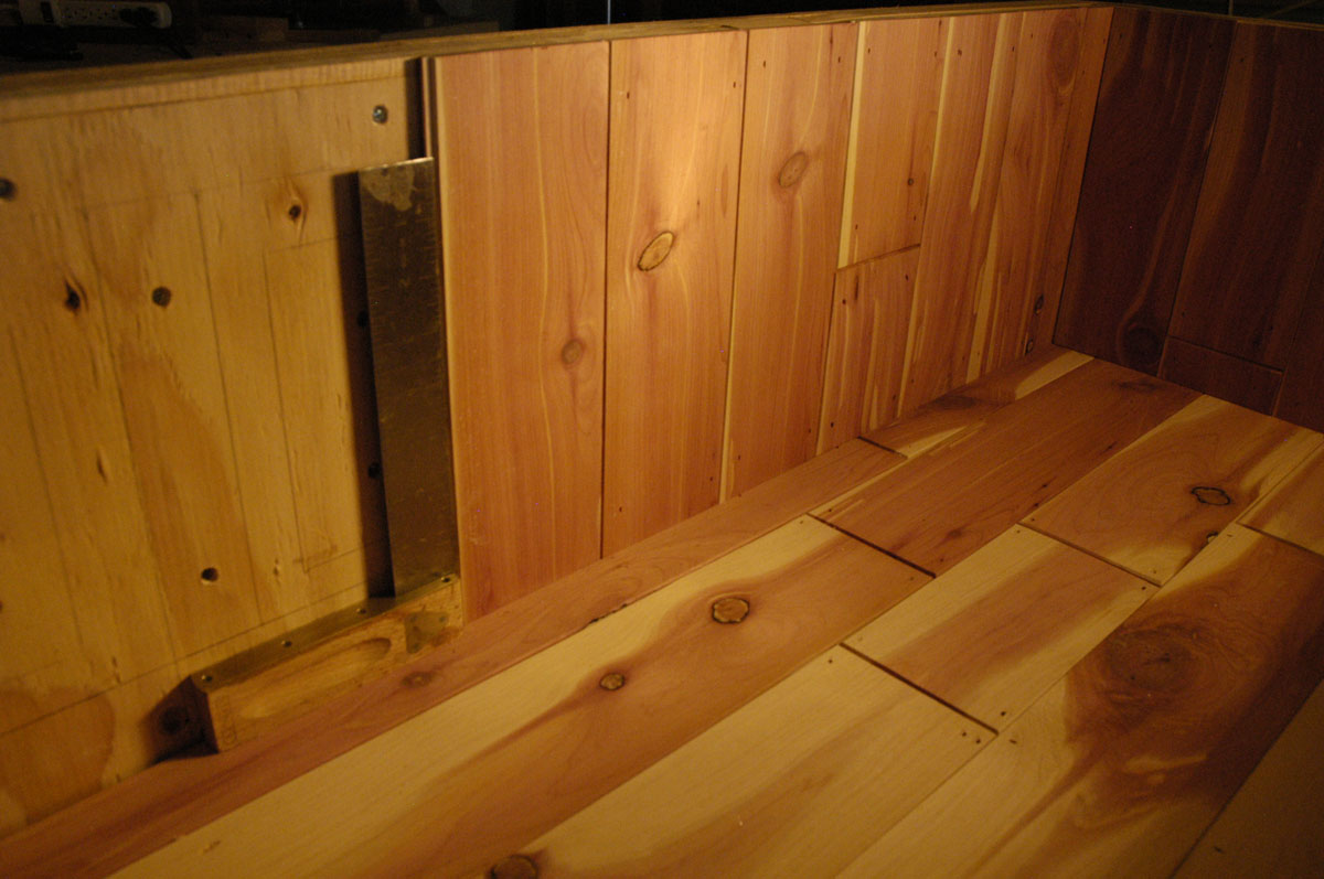 Tongue-and-groove cedar is affixed to the interior of the plywood box.