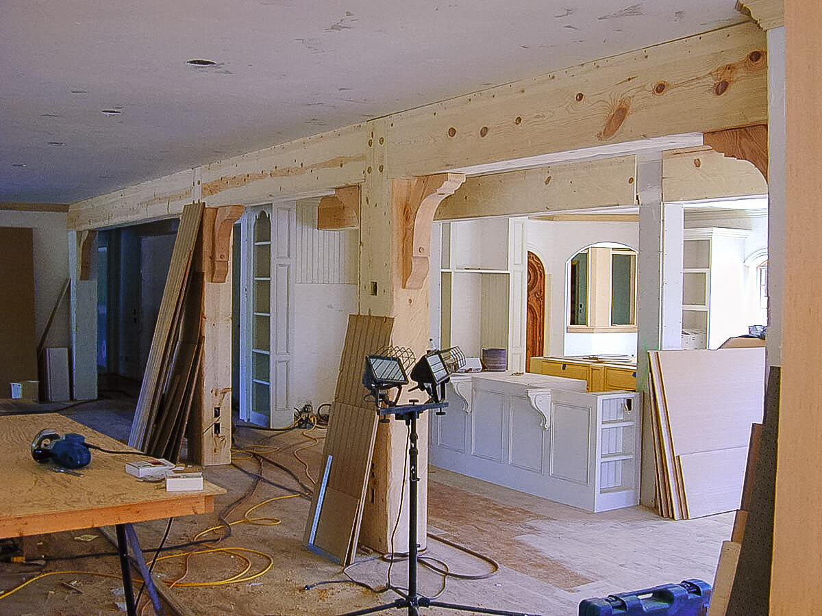 Posts, beams, and corbels are partially installed.
