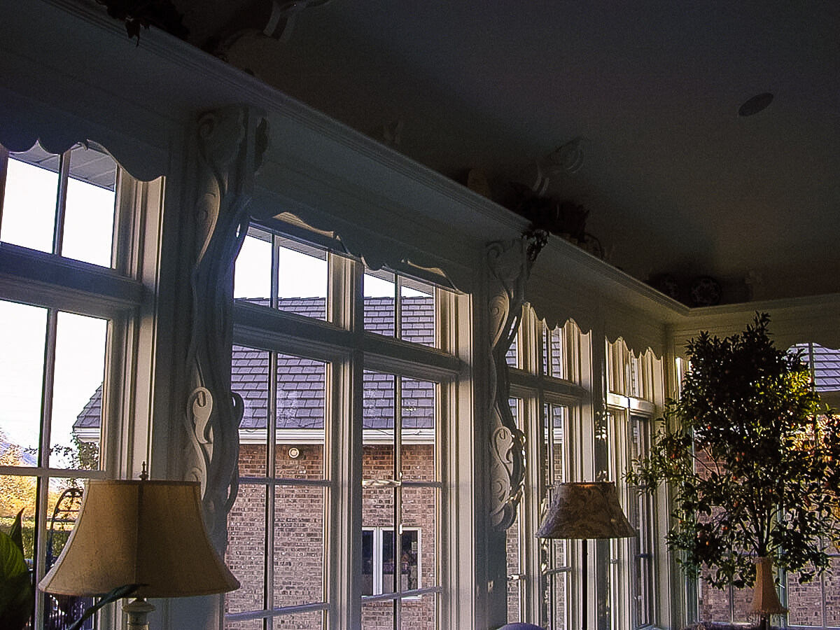 Uniquely designed corbels accent the plate rail in a garden room.  See more . . .