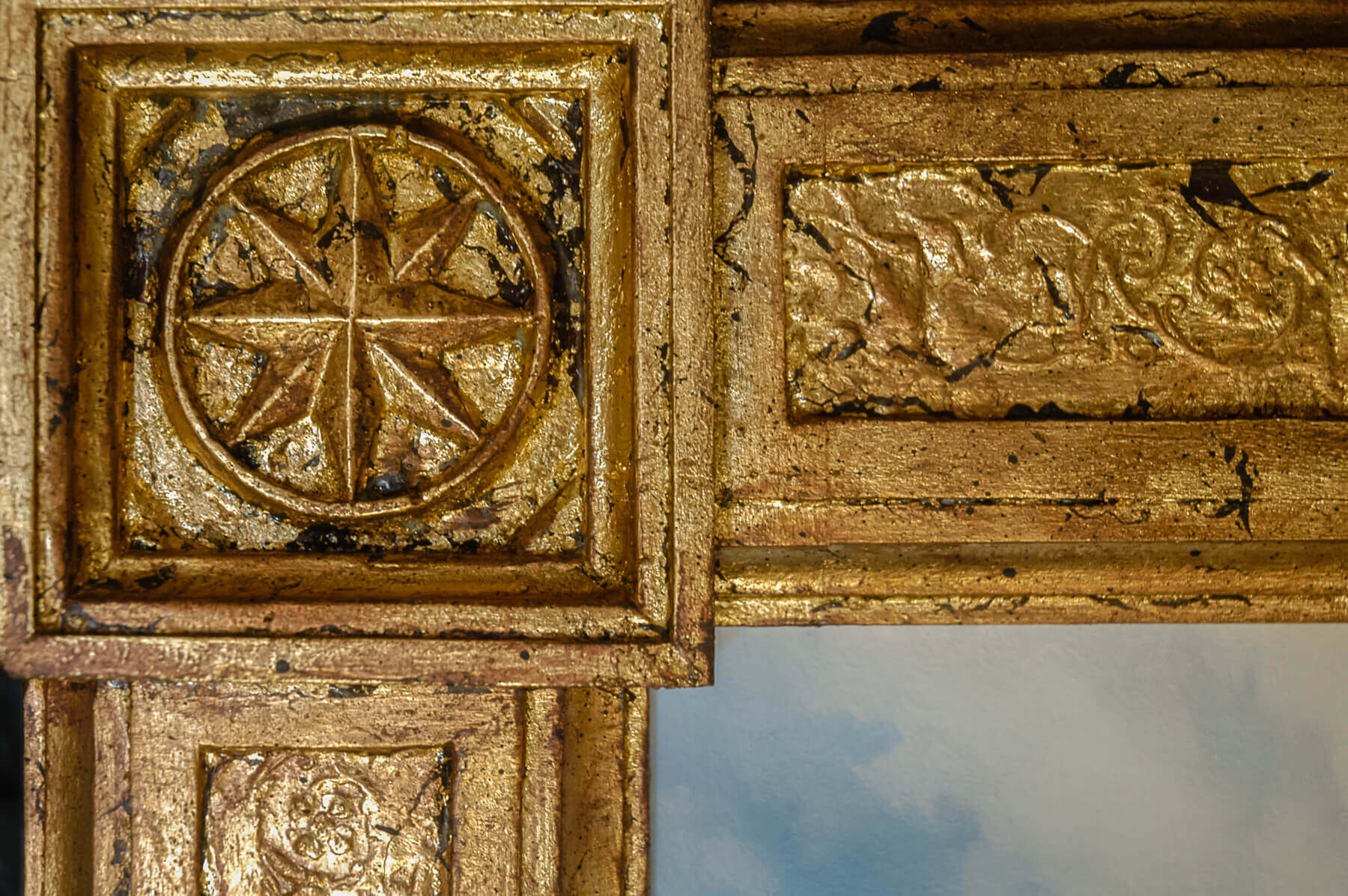 This close-up of one of the frame corners shows the hand-done gilding, antiquing, and finishing that...