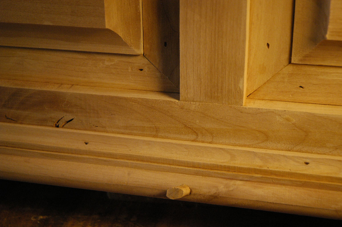 Exposed areas of plywood have been covered with thin strips of alder.  Holes in the alder ...