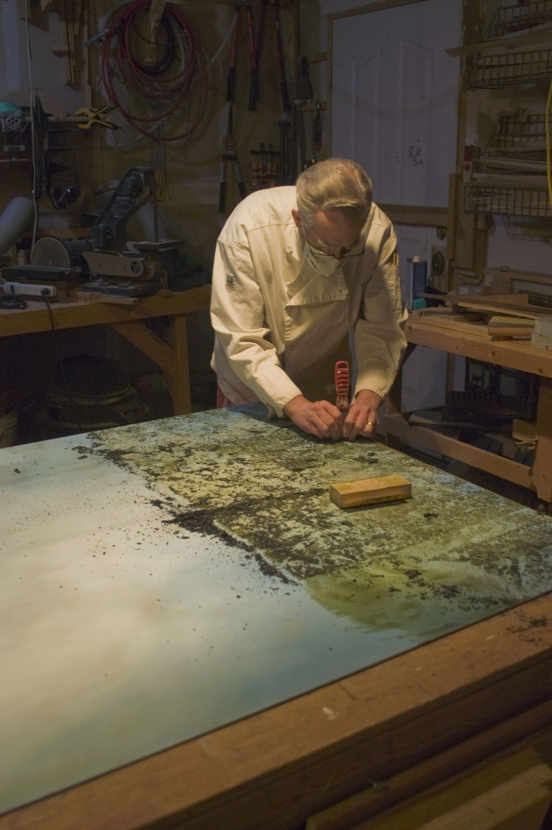 Masked and bespectacled, I am in our woodworking shop scraping away the imprimatura.&nbsp;&nbsp;Hold...