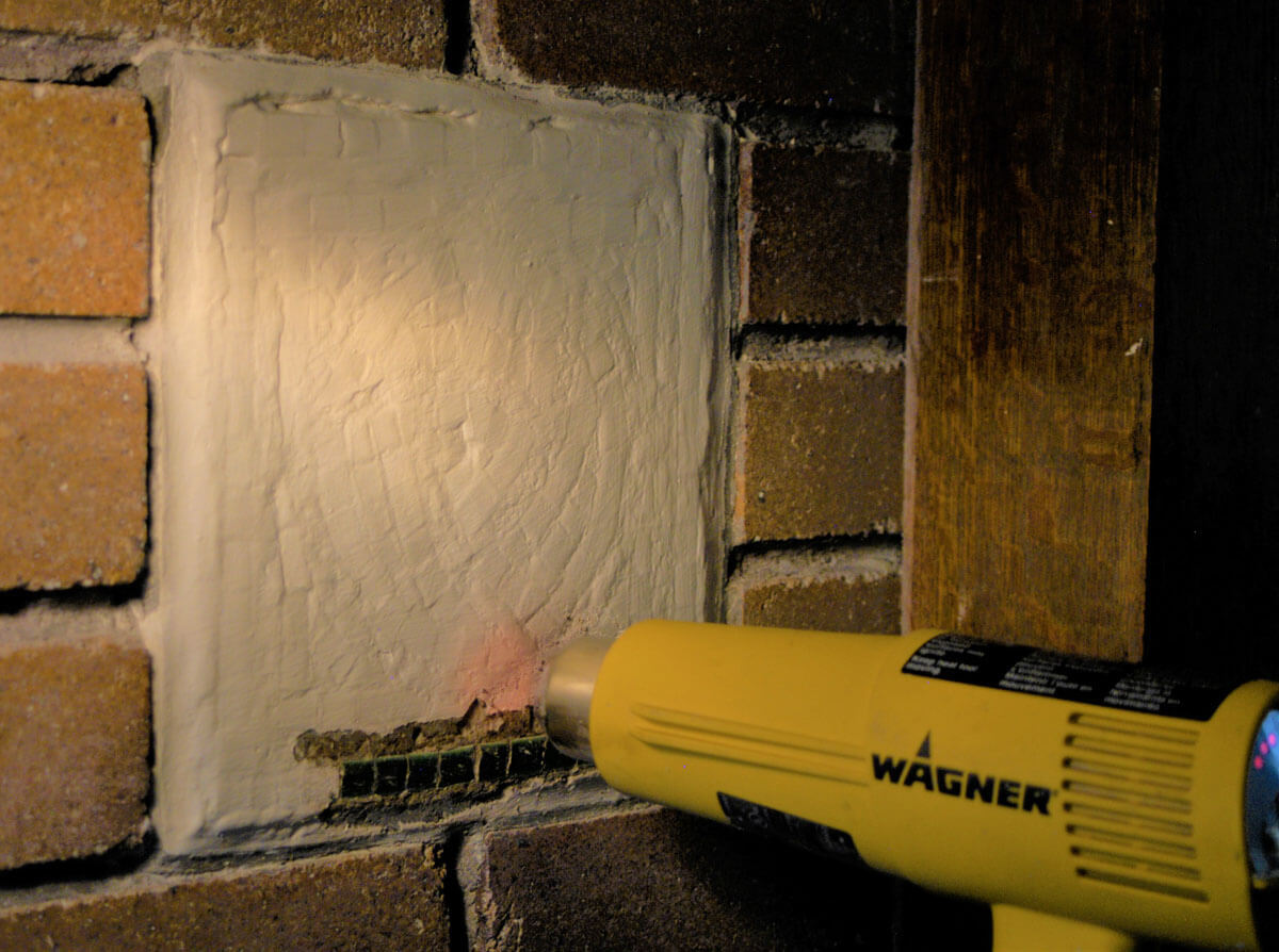 A heat gun softens the paint on top of the mosaic.&nbsp;&nbsp;Working on a few square inches at a ti...